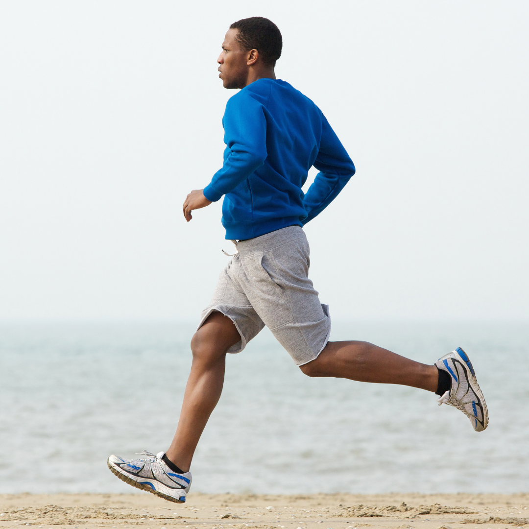 Healthy man running on beach